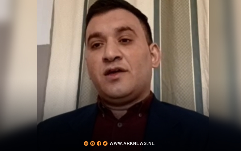 An activist for ARK, showing the latest statistics of the revolution: 700 martyrs, thousands of detainees, and hundreds of missing persons