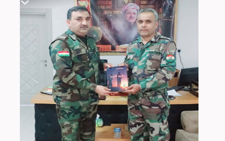 Peshmerga Abdul Hadi Darwish signs his book 