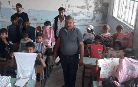 Distribution the uniform to pupils by the local council in rural Afrin
