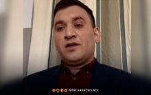 An activist for ARK, showing the latest statistics of the revolution: 700 martyrs, thousands of detainees, and hundreds of missing persons